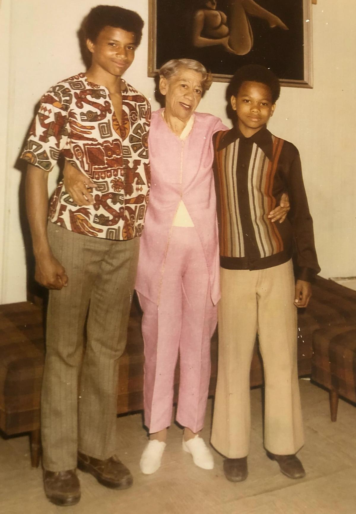 Andre Butler, as a teenager, poses with his grandmother and younger brother.