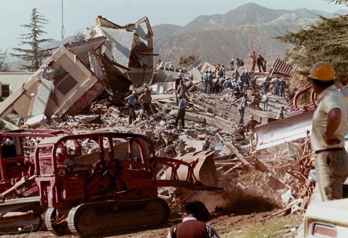 Workmen clear debris and rubble from collapsed buildings at the Veterans Hospital in Sylmar, California, after a massive earthquake hit the area on Feb. 9, 1971.