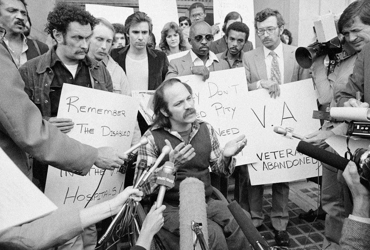 Vietnam Veteran Ron Kovic, in a wheelchair, holds a sidewalk news conference Jan. 30, 1981, in Los Angeles.
